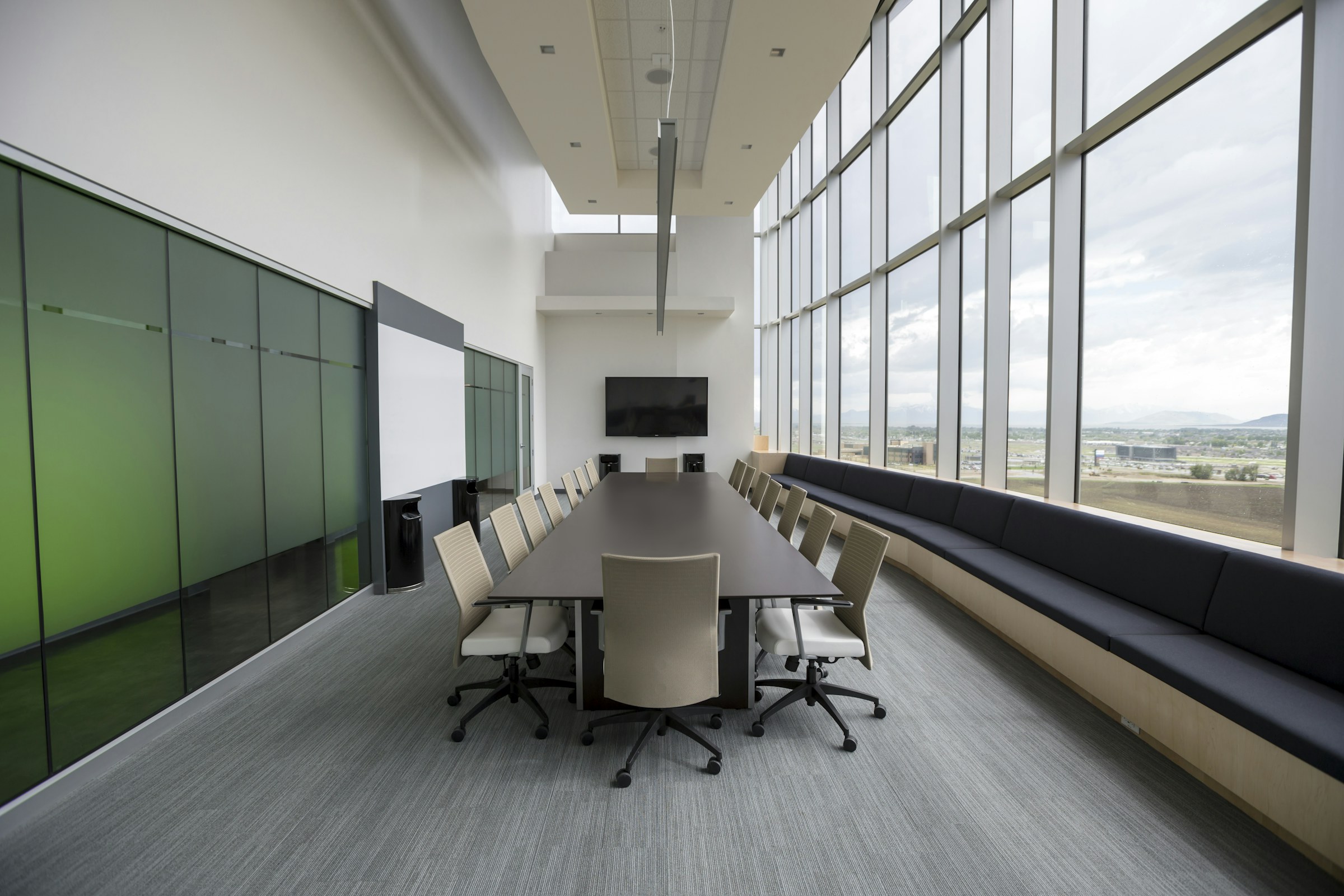 Empty partnership boardroom with a long wooden conference table and chairs